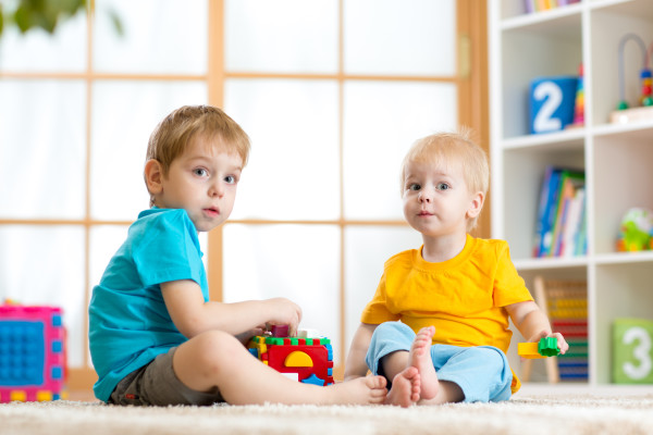 kids play together with educational toys in nursery